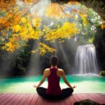 41619177 - young woman in yoga pose sitting near watefall rear view
